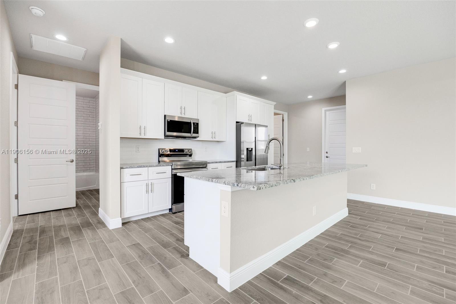 626 Royce Road LaBelle, FL 33935 - Photo 9 of 40 a large white kitchen with wooden floor
