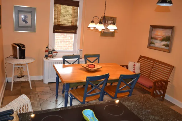 a view of a dining room with furniture and chandelier