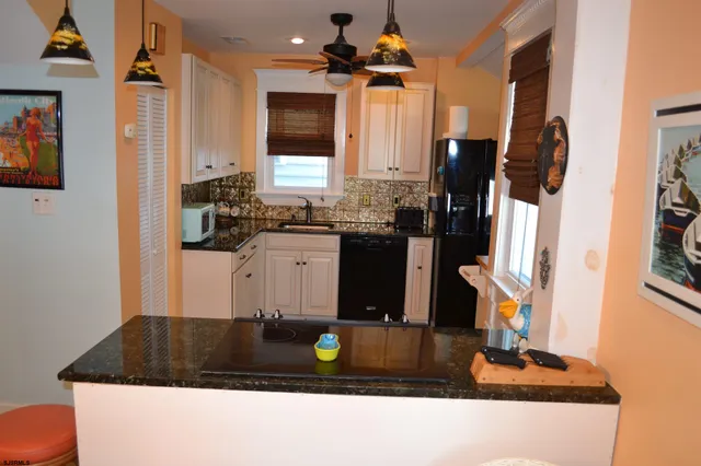 a kitchen with a sink and a stove top oven