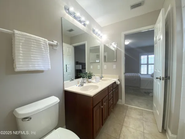 a bathroom with a sink toilet and mirror