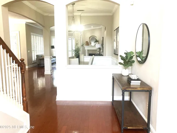 a view of a hallway with furniture and a potted plant