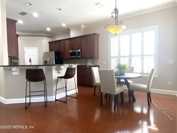 a view of a dining room with furniture and a window