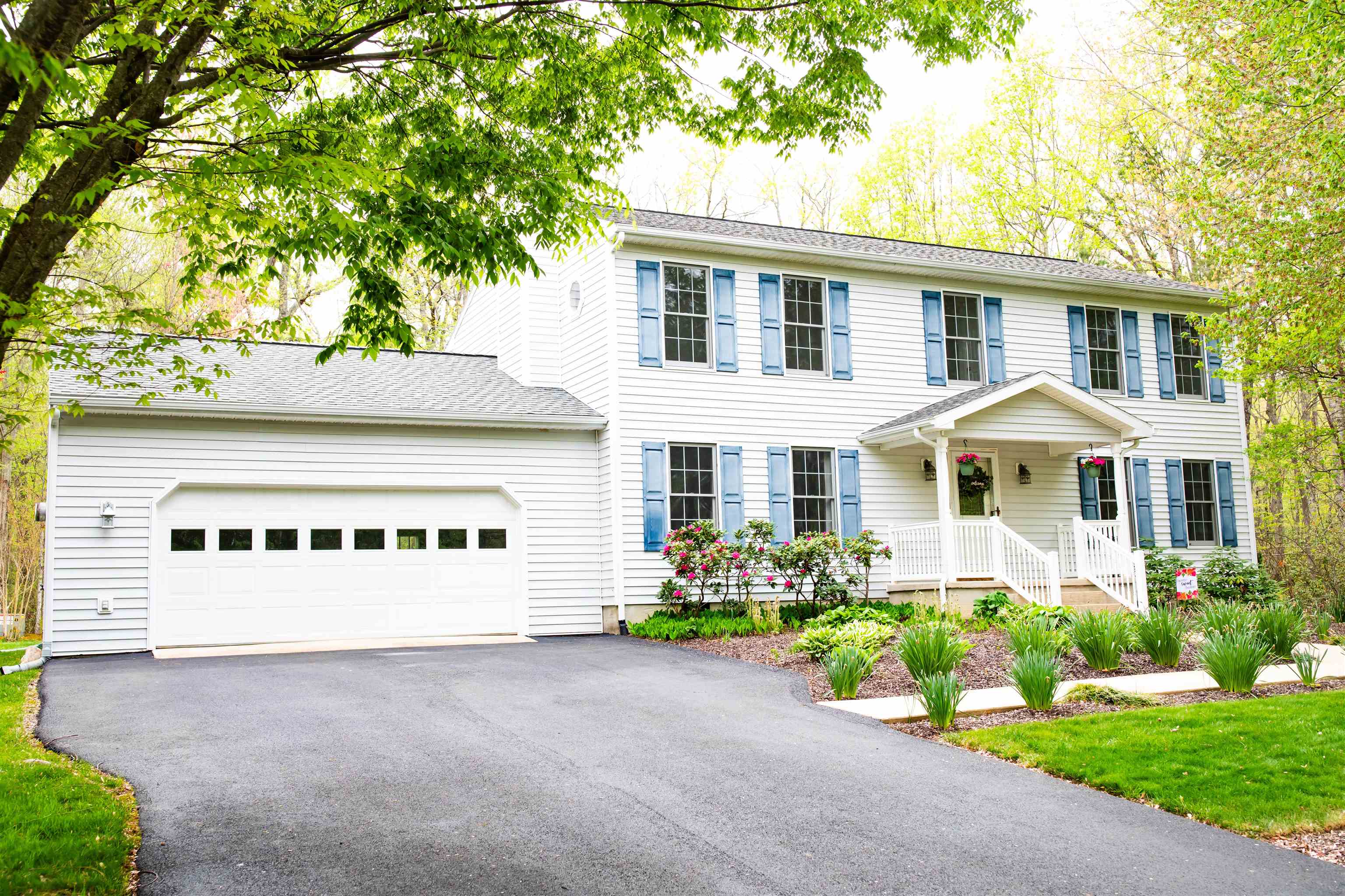 a front view of a house with a yard and outdoor seating