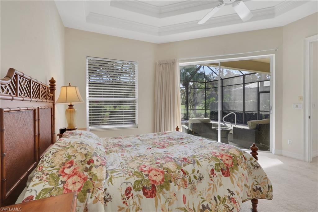 3134 Santorini Court Naples, FL 34119 - Photo 15 of 21 a bedroom with a large bed and a large window