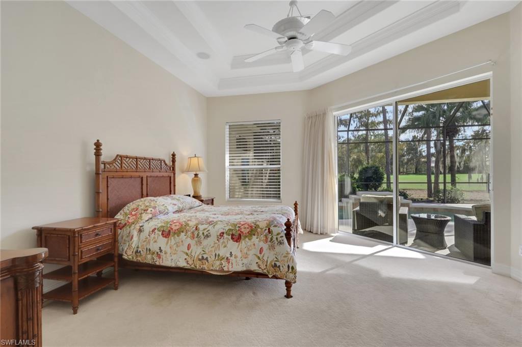 3134 Santorini Court Naples, FL 34119 - Photo 16 of 21 a bedroom with a bed chair and a large window