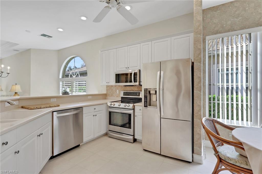 3134 Santorini Court Naples, FL 34119 - Photo 5 of 21 a kitchen with a refrigerator stove and sink