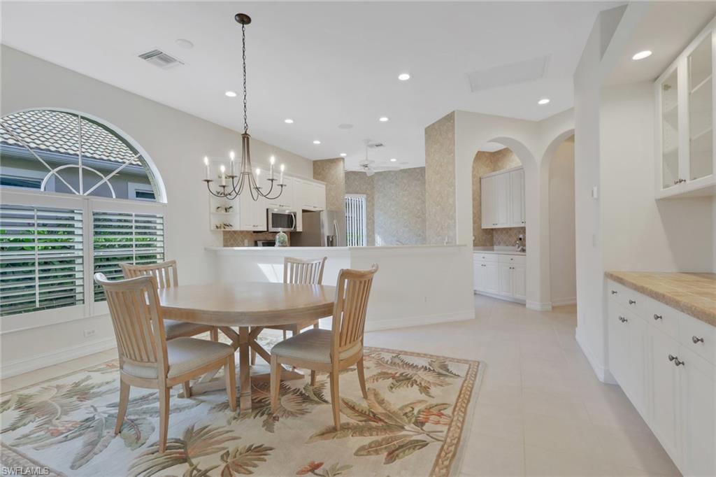 3134 Santorini Court Naples, FL 34119 - Photo 8 of 21 a view of a dining room with furniture