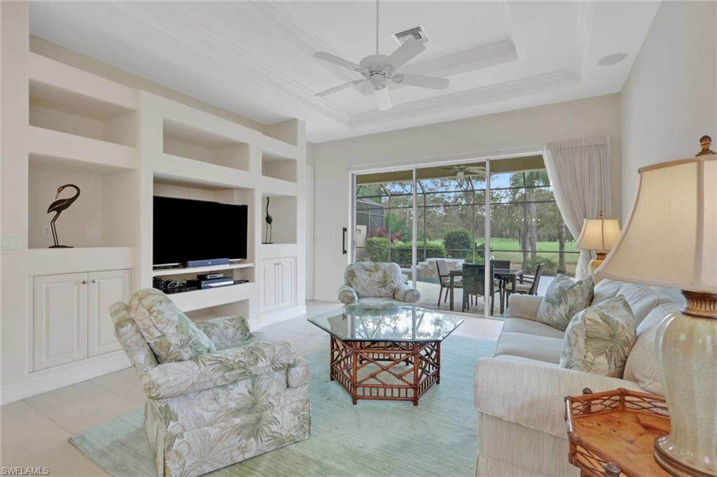 3134 Santorini Court Naples, FL 34119 - Photo 10 of 21 a living room with furniture and a flat screen tv