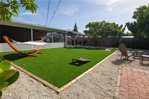 a view of a backyard with sitting area