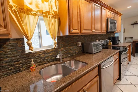 a kitchen with a sink a counter top space and cabinets
