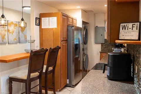 a kitchen with dining area and stainless steel appliances