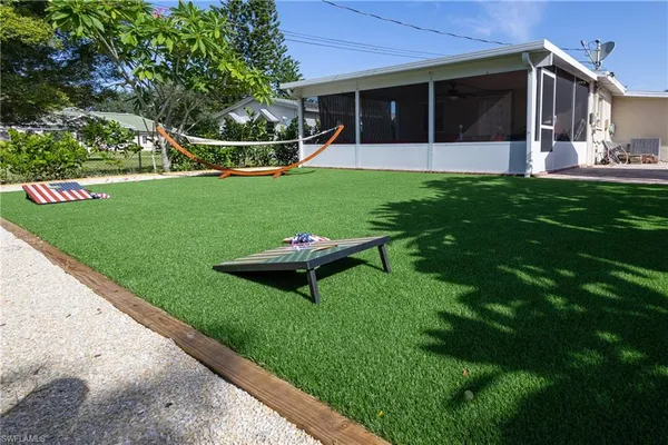 a view of a house with backyard and porch
