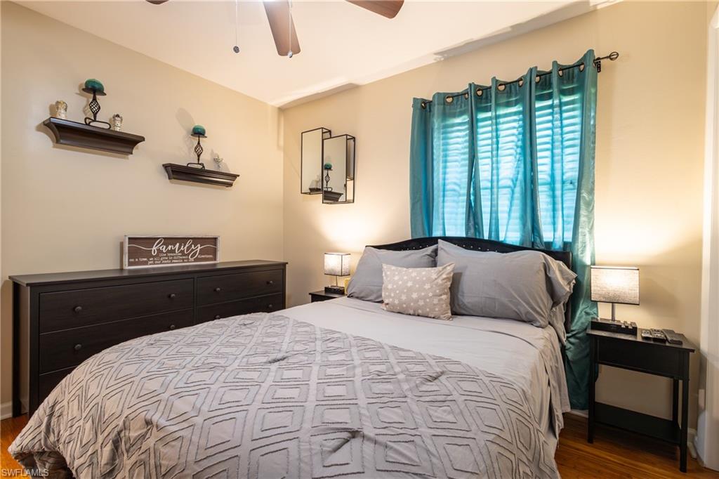 806 97th Avenue North Naples, FL 34108 - Photo 22 of 27 a bedroom with a large bed and a window