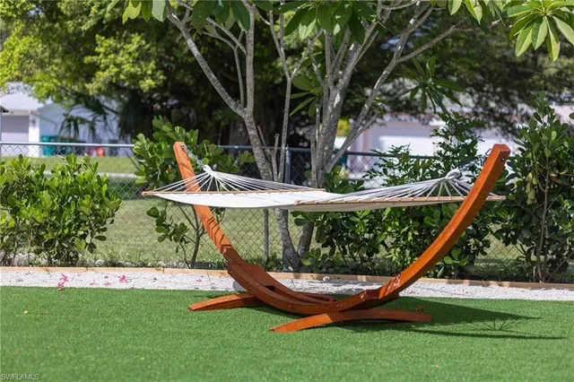 a view of a backyard with large trees