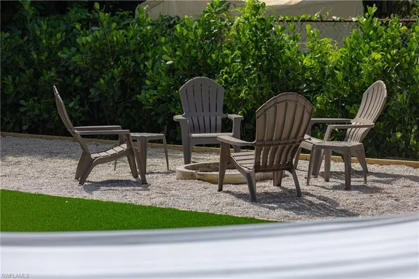 a view of a chairs and bench in the ground