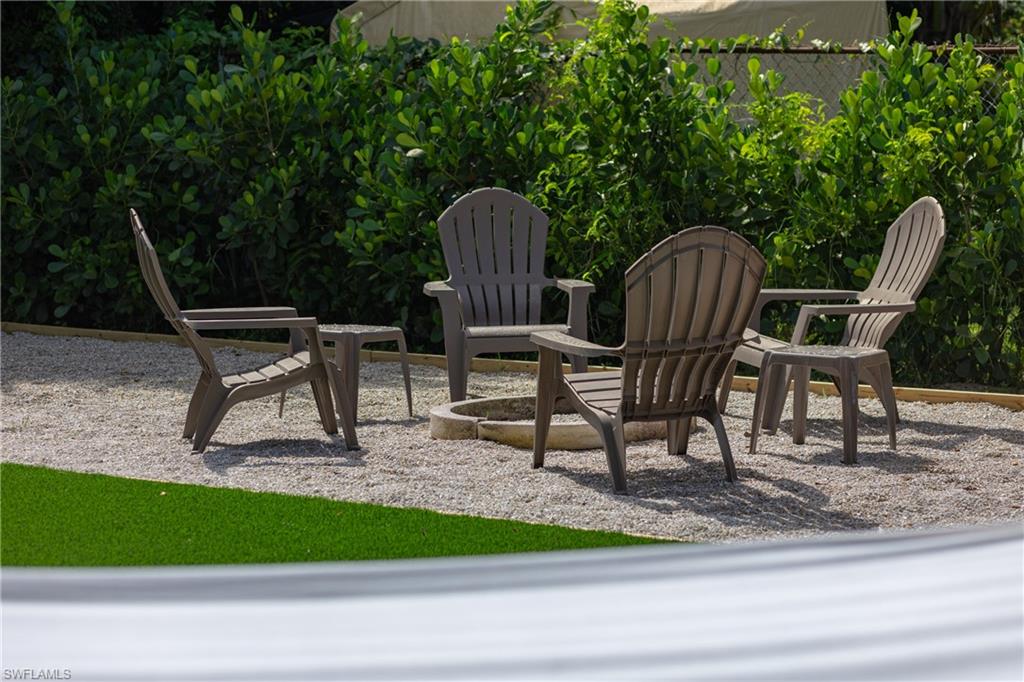 806 97th Avenue North Naples, FL 34108 - Photo 5 of 27 a view of a chairs and bench in the ground