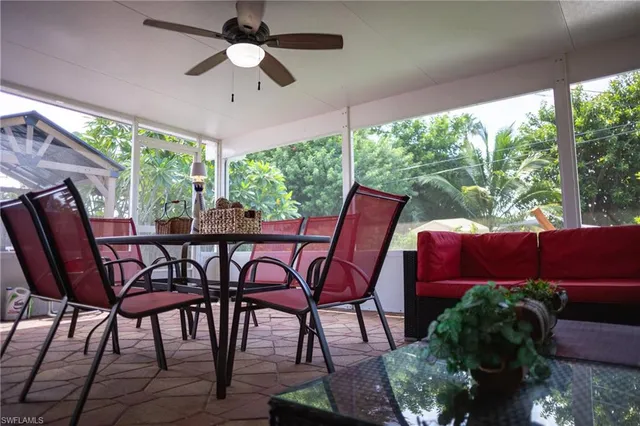 a view of a patio with a table chairs and a backyard