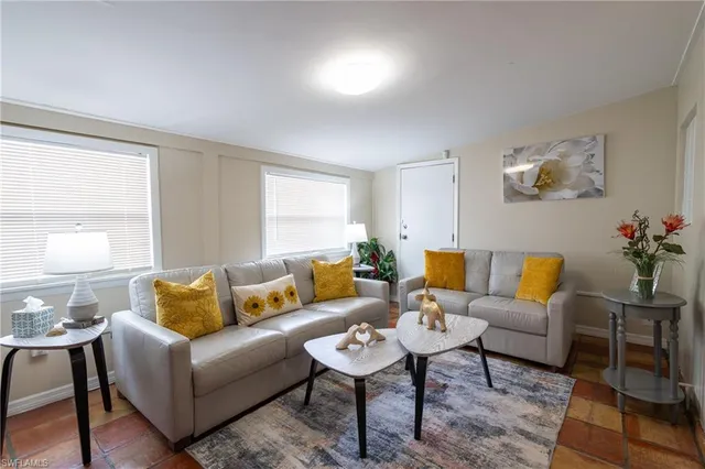 a living room with furniture and a potted plant