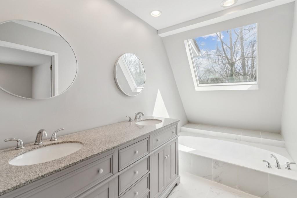 355 Westerhall Court Sandy Springs, GA 30328 - Photo 17 of 37 a bathroom with a granite countertop sink mirror and bathtub