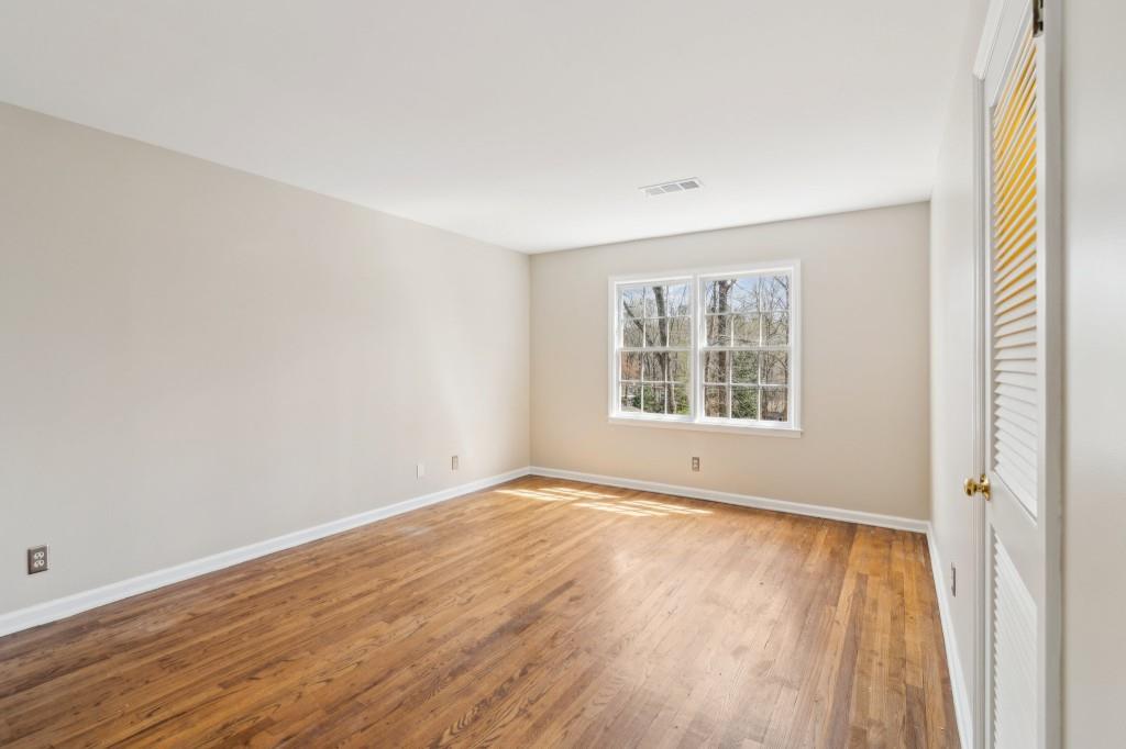 355 Westerhall Court Sandy Springs, GA 30328 - Photo 21 of 37 a view of an empty room with wooden floor and a window