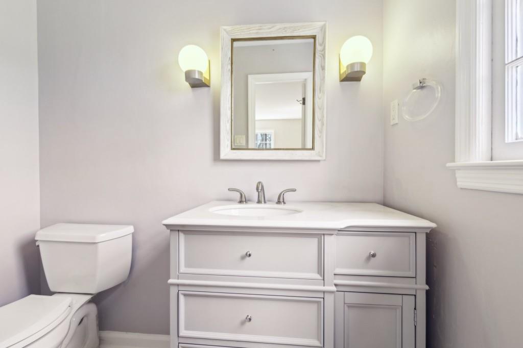 355 Westerhall Court Sandy Springs, GA 30328 - Photo 22 of 37 a bathroom with a toilet sink and mirror