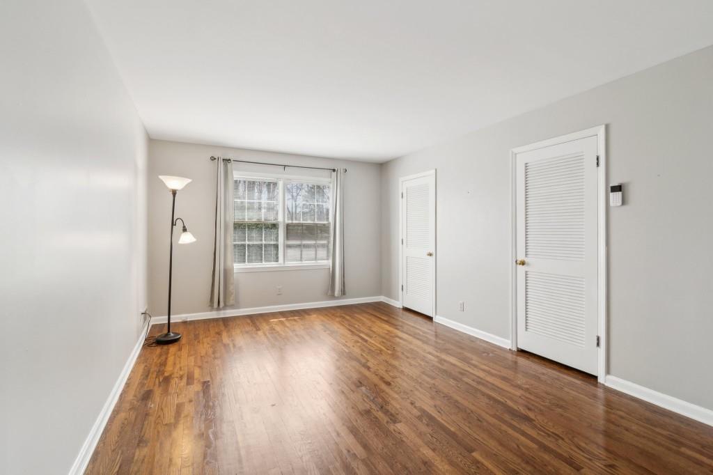 355 Westerhall Court Sandy Springs, GA 30328 - Photo 24 of 37 a view of an empty room with wooden floor and a window