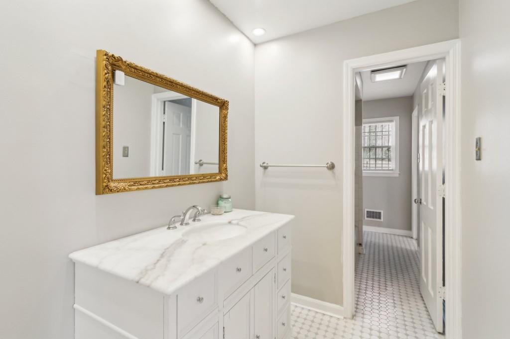 355 Westerhall Court Sandy Springs, GA 30328 - Photo 25 of 37 a bathroom with a sink a light fixture and a mirror