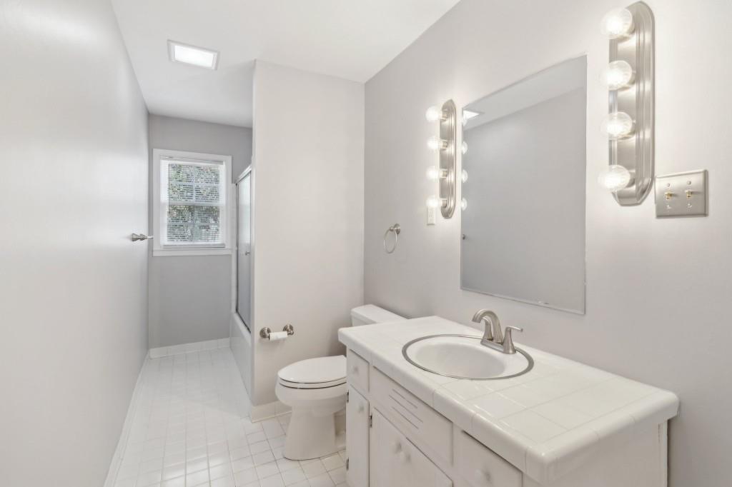 355 Westerhall Court Sandy Springs, GA 30328 - Photo 27 of 37 a bathroom with a sink toilet vanity and shower