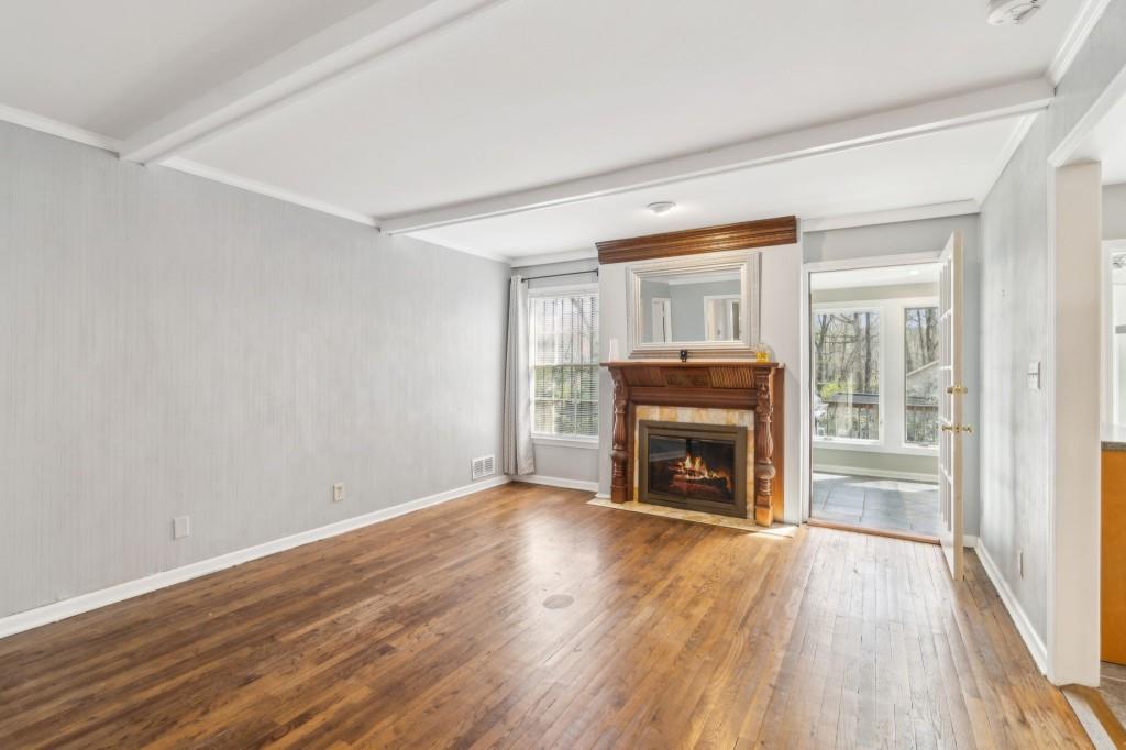 355 Westerhall Court Sandy Springs, GA 30328 - Photo 7 of 37 a view of an empty room with wooden floor fireplace and a window