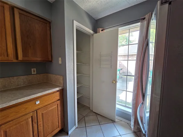 a kitchen with a refrigerator and cabinets