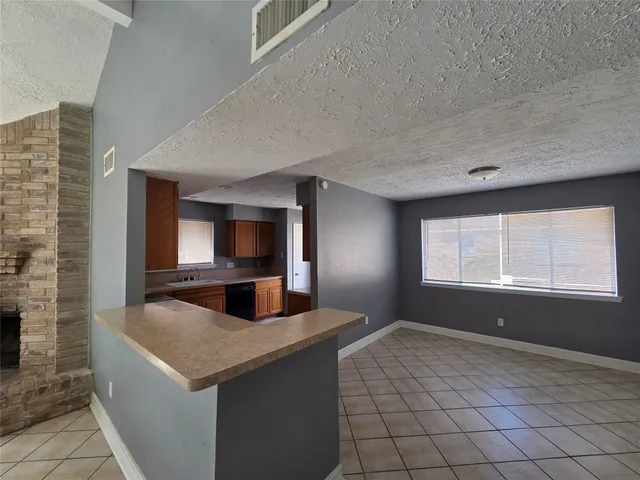 a kitchen with granite countertop a sink and a stove top oven