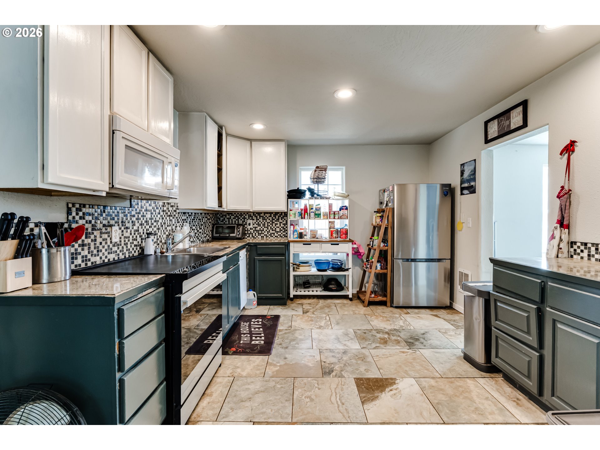 525 21st Street Springfield, OR 97477 - Photo 13 of 33 a kitchen with stainless steel appliances granite countertop a refrigerator and a stove top oven