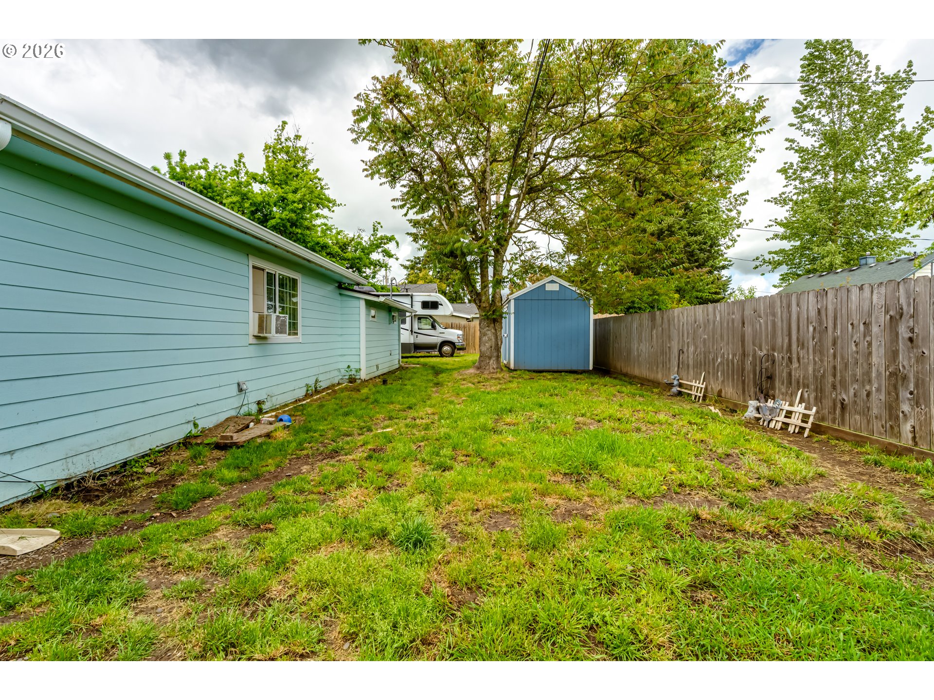 525 21st Street Springfield, OR 97477 - Photo 30 of 33 a backyard of a house with plants and large tree