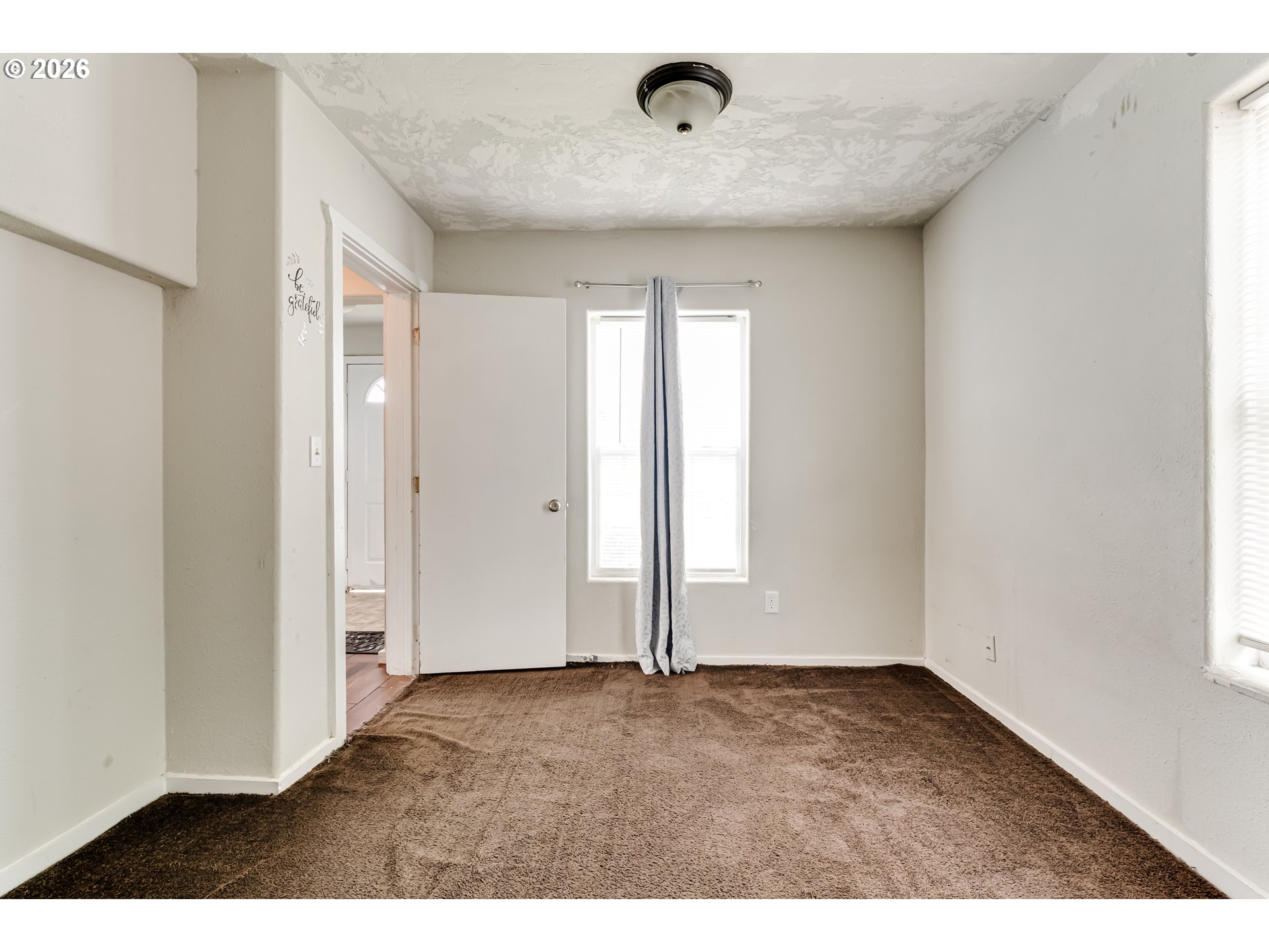 525 21st Street Springfield, OR 97477 - Photo 8 of 33 an empty room with wooden floor and windows