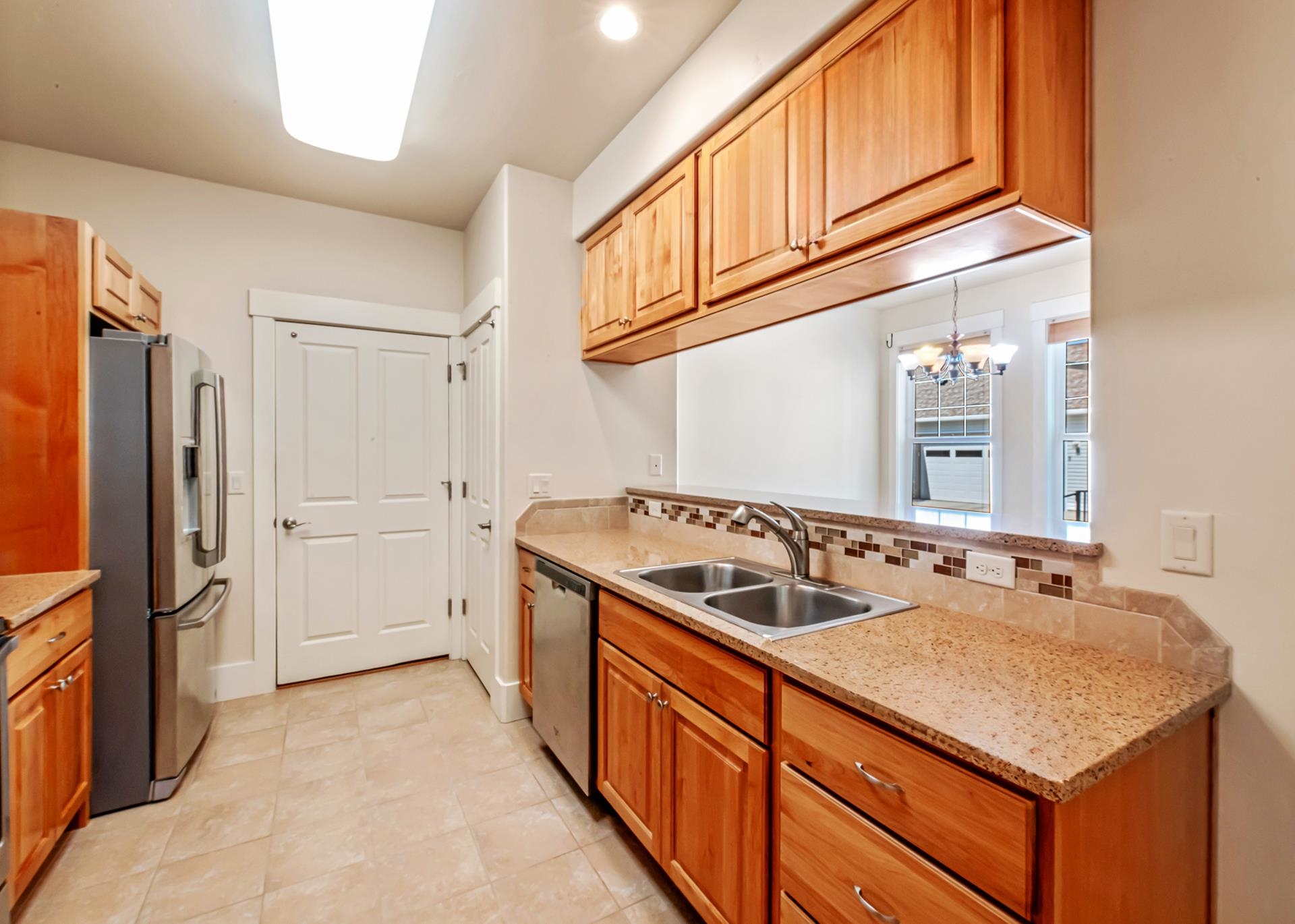 1215 Sunrose Lane, Unit 342 Fruita, CO 81521 - Photo 5 of 19 a kitchen with stainless steel appliances granite countertop a sink and a refrigerator