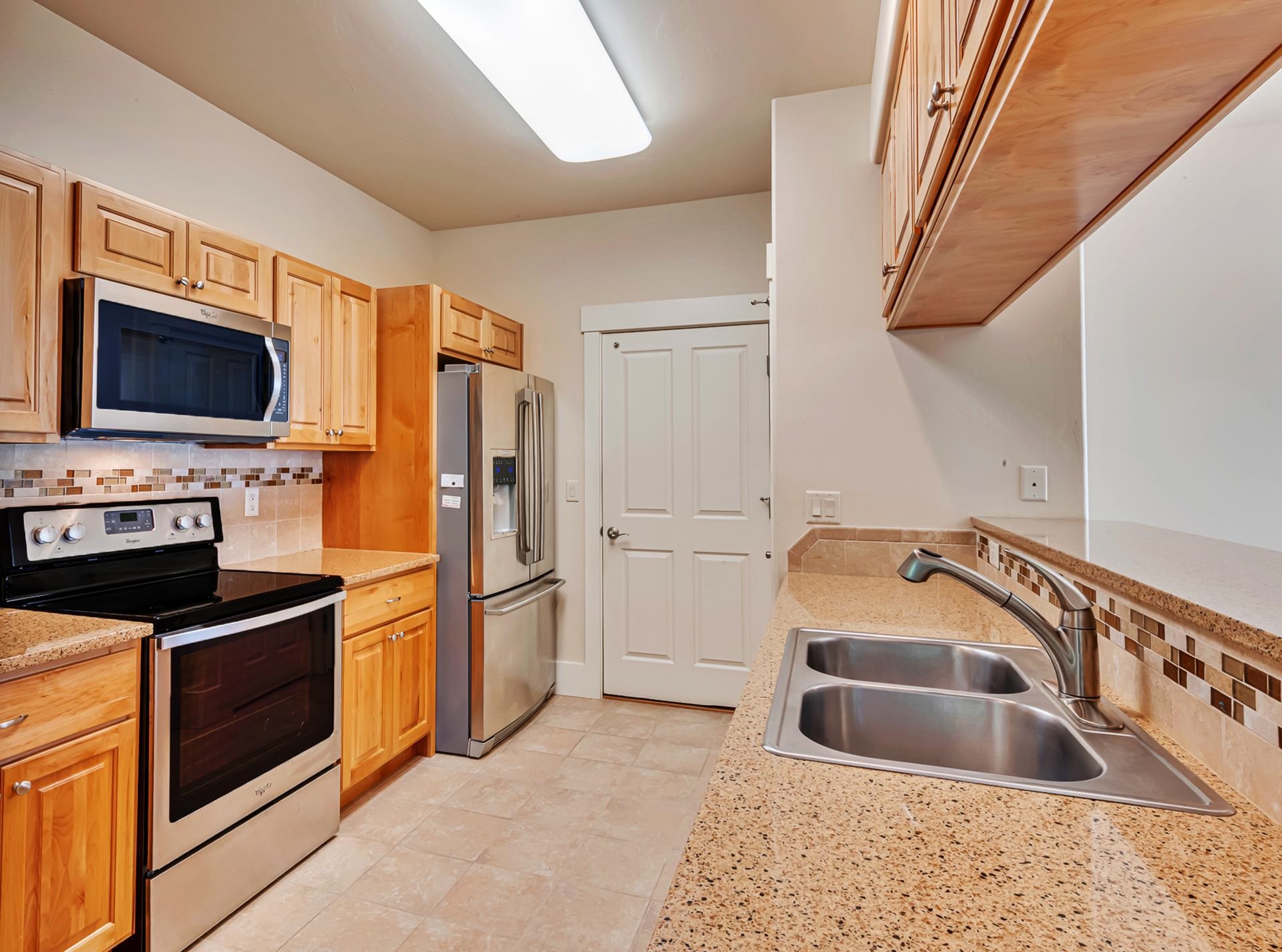 1215 Sunrose Lane, Unit 342 Fruita, CO 81521 - Photo 6 of 19 a kitchen with a sink cabinets and stainless steel appliances