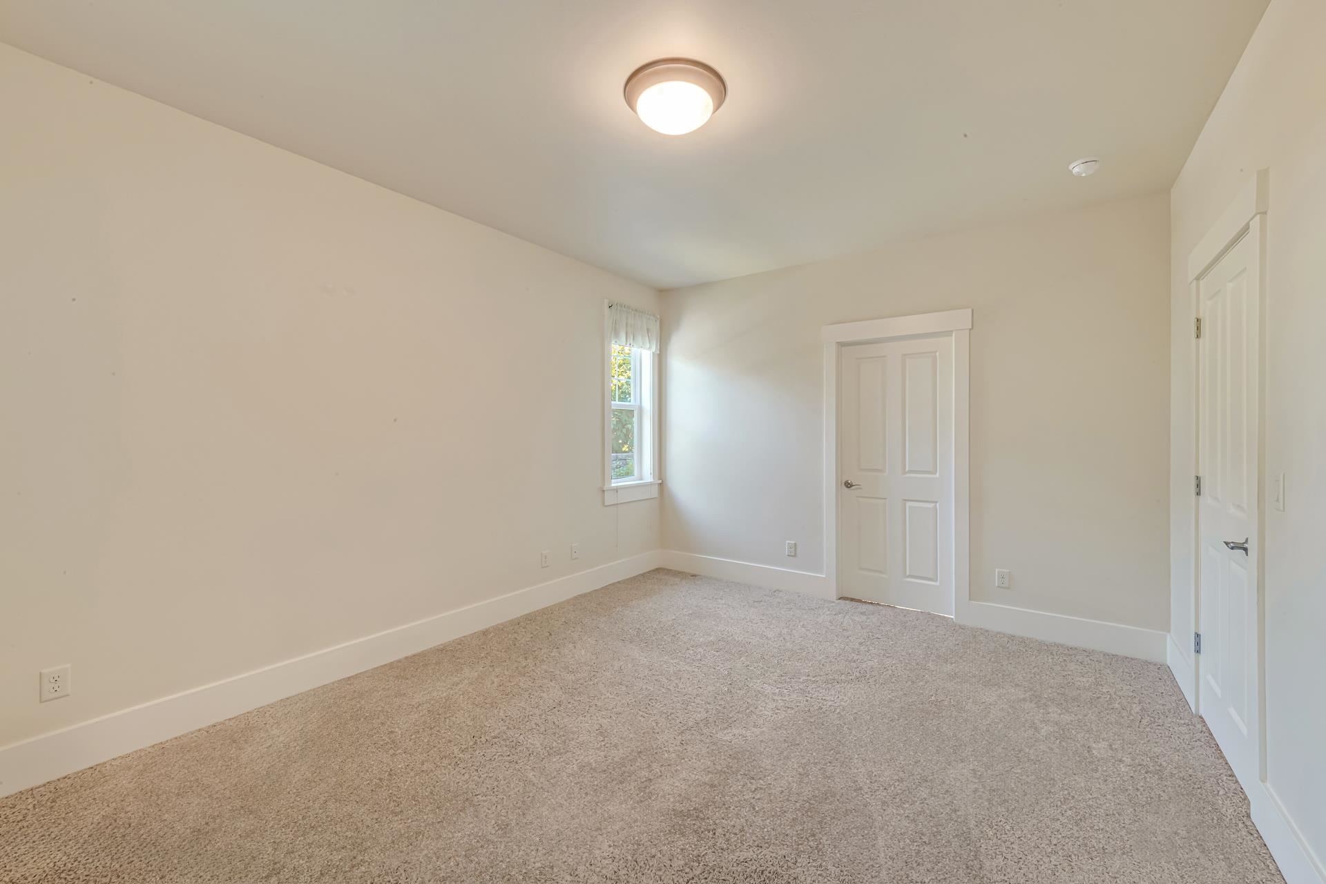 1215 Sunrose Lane, Unit 342 Fruita, CO 81521 - Photo 8 of 19 an empty room with window and pillar in it