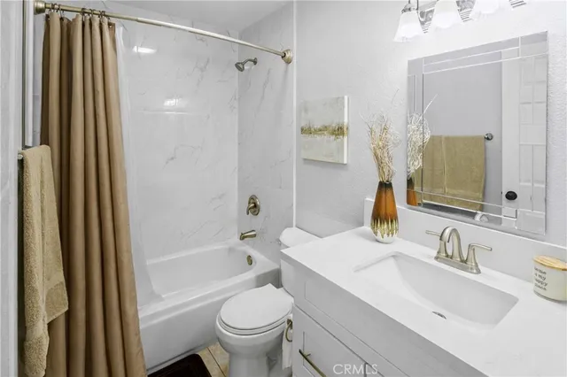 a bathroom with double vanity sink and a mirror