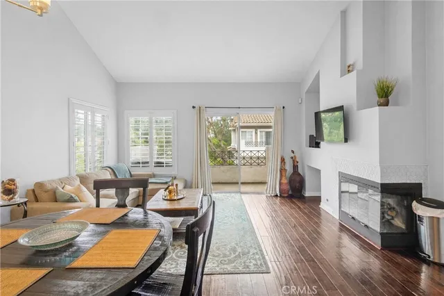 a living room with fireplace furniture and a wooden floor