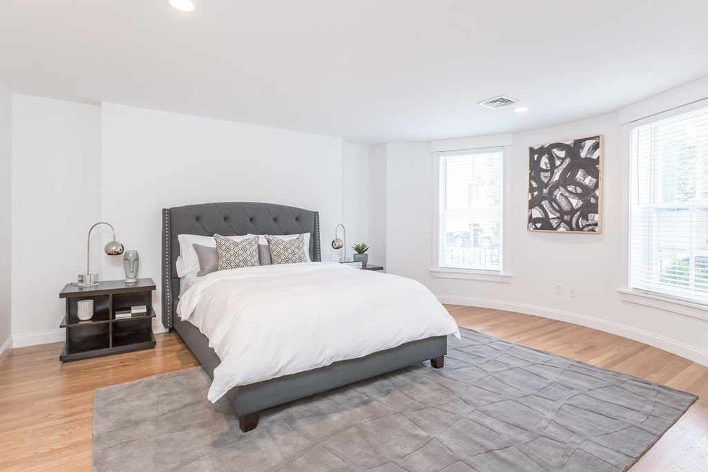 61 Dartmouth Street, Unit 1 Boston, MA 02116 - Photo 11 of 24 a bedroom with a bed and wooden floor