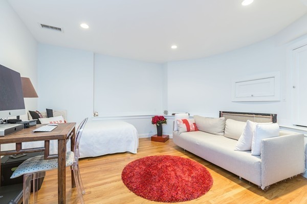61 Dartmouth Street, Unit 1 Boston, MA 02116 - Photo 20 of 24 a living room with furniture and a wooden floor