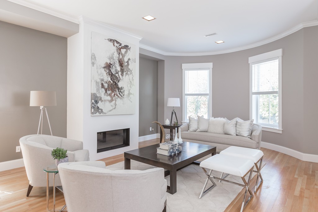 61 Dartmouth Street, Unit 1 Boston, MA 02116 - Photo 2 of 24 a living room with furniture a table and a large window