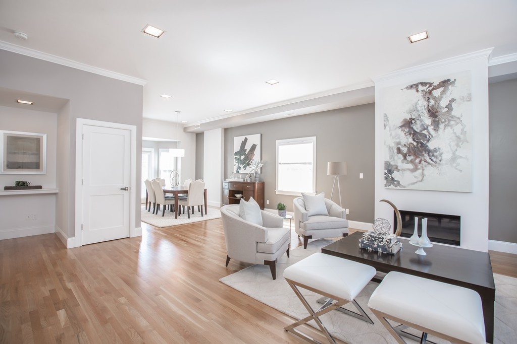 61 Dartmouth Street, Unit 1 Boston, MA 02116 - Photo 3 of 24 a living room with furniture and a fireplace