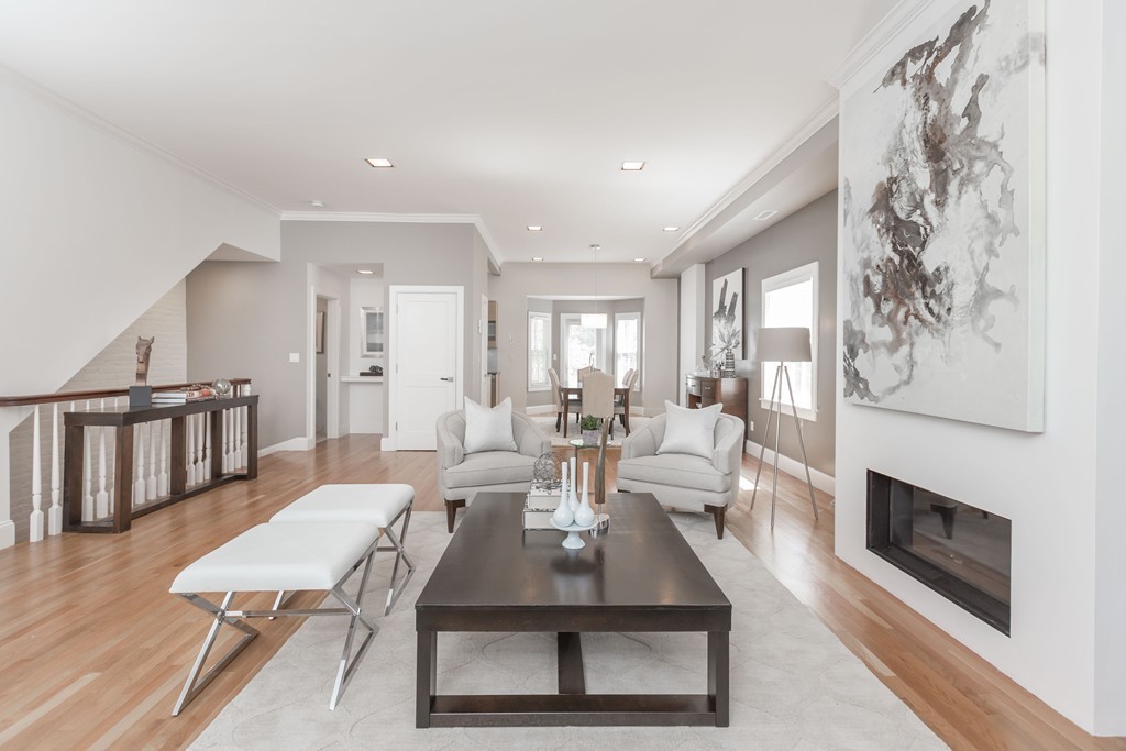 61 Dartmouth Street, Unit 1 Boston, MA 02116 - Photo 4 of 24 a living room with furniture a fireplace and a table with wooden floor