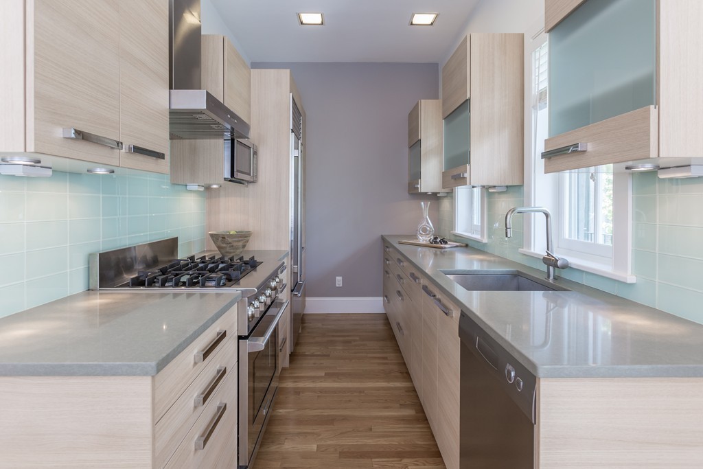 61 Dartmouth Street, Unit 1 Boston, MA 02116 - Photo 7 of 24 a kitchen with stainless steel appliances granite countertop a sink stove and cabinets