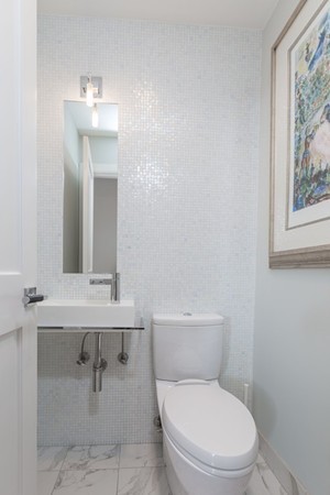 61 Dartmouth Street, Unit 1 Boston, MA 02116 - Photo 8 of 24 a white toilet sitting next to a bathroom sink
