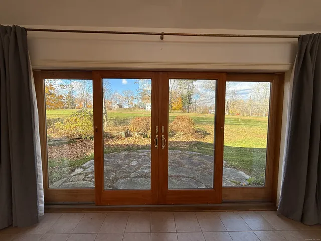 a spacious bathroom with a tub and mirror