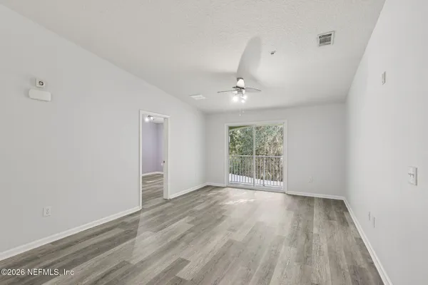 a view of a house with backyard and trees