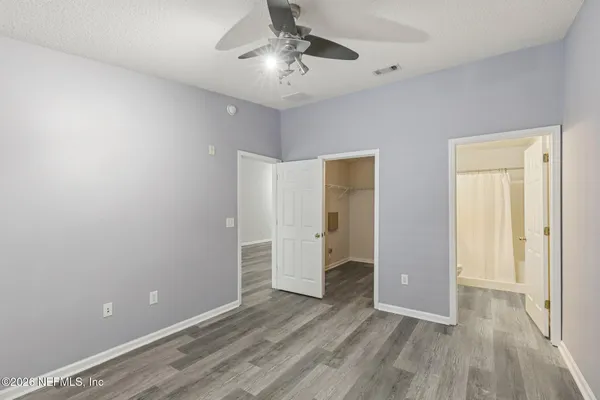 a bedroom with a bed and a potted plant