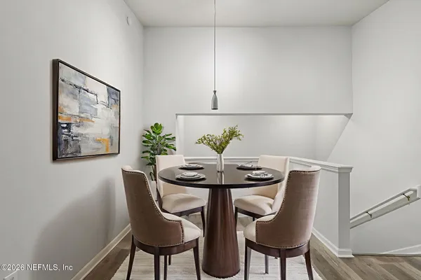 a bedroom with a large bed and a potted plant